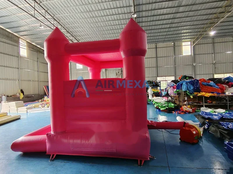 Castillo inflable rosa compacto con resbaladilla y alberca de pelotas para niños