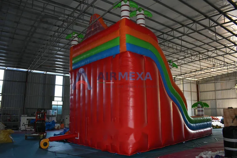 Resbaladilla inflable doble carril con temática de dinosaurios y volcán