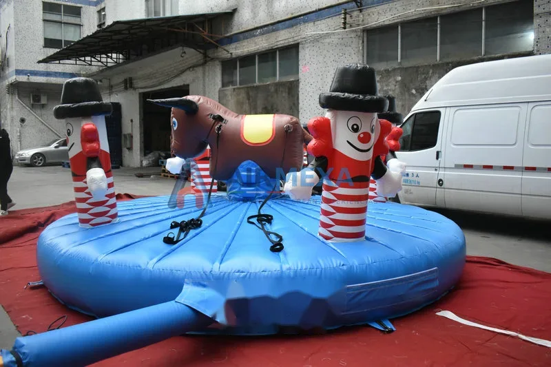 Toro inflable mecánico sobre colchón de aterrizaje en evento al aire libre